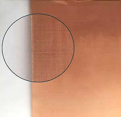 A piece of woven copper mesh in plain woven type stay on the paper.
