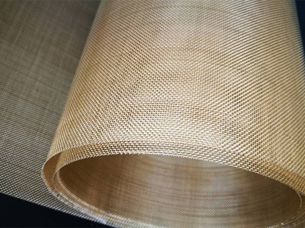 A roll of brass wire mesh with golden yellow color.