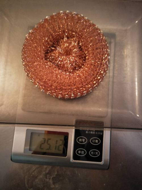 A copper scrubber is placed on the electronic weigher.