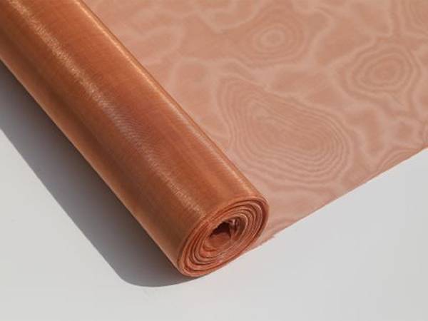 A roll of fine copper mesh on white background