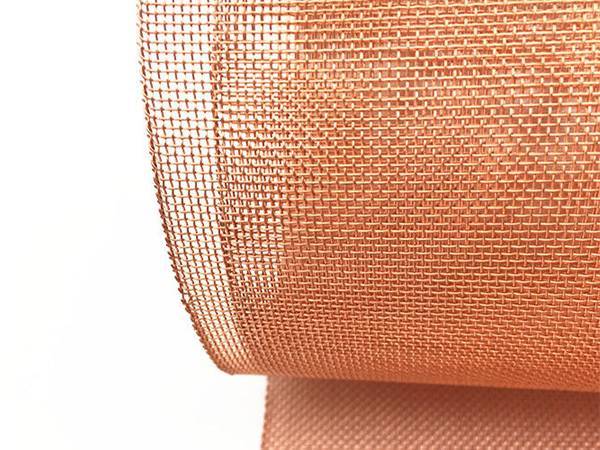 A roll of medium copper mesh on white background