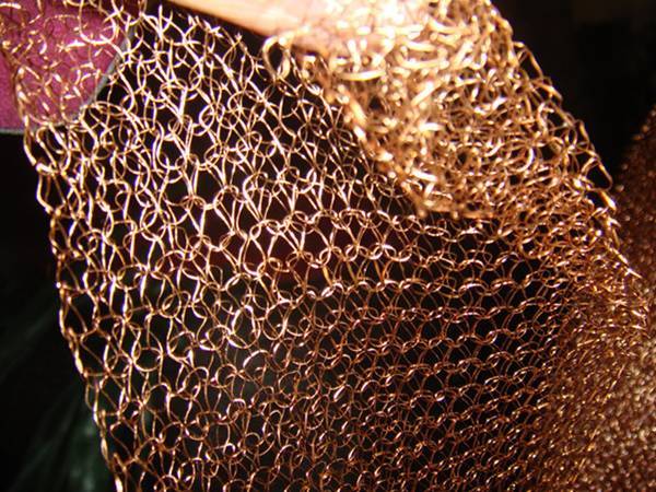 A piece of copper knitted mesh with single flat wire and double layer structure.