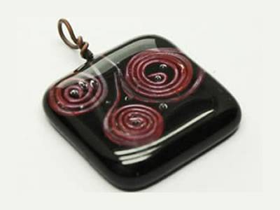 Red copper spiral on black fused glass pendant
