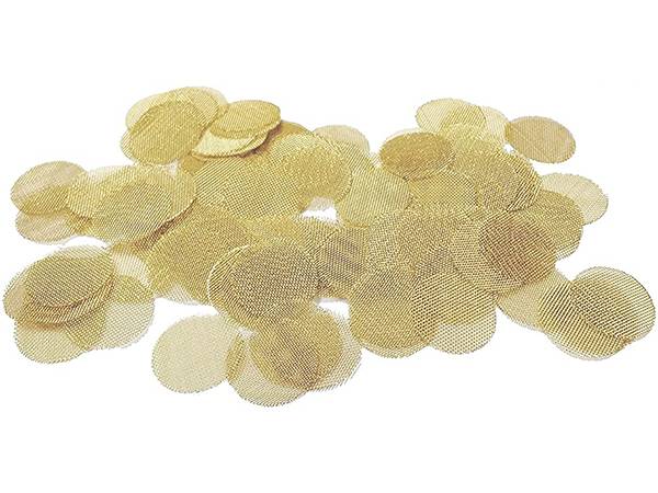 Several pieces of brass wire mesh filter discs on white background.