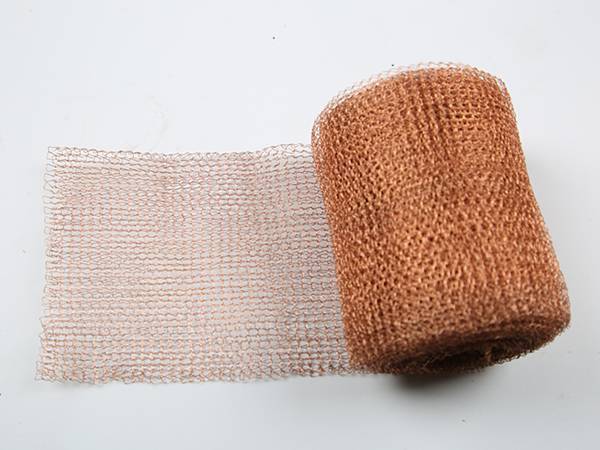 A roll of 100% copper shielding mesh on gray background.