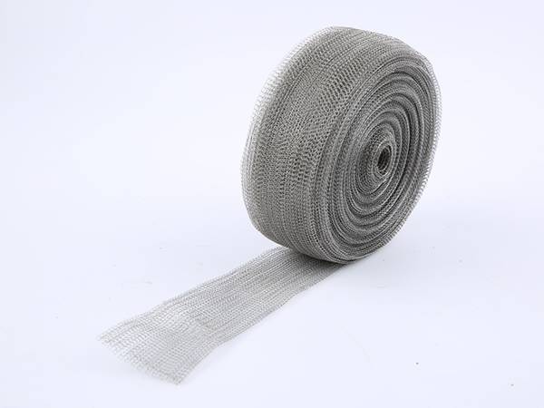 A roll of tinned copper cable shielding mesh on gray background.