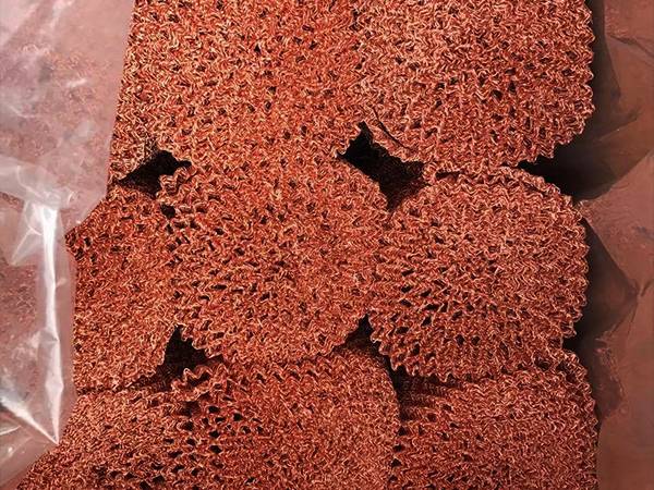 Several rolls of knitted copper mesh in a plastic bag