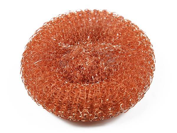A piece of knitted mesh copper scrubber on white background.