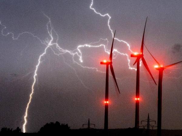 Wind turbine is in lightning weather conditions.