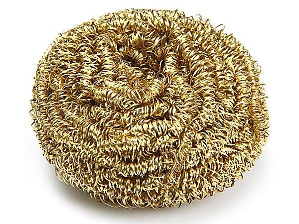 A piece of brass spiral wire copper scrubber on white background.